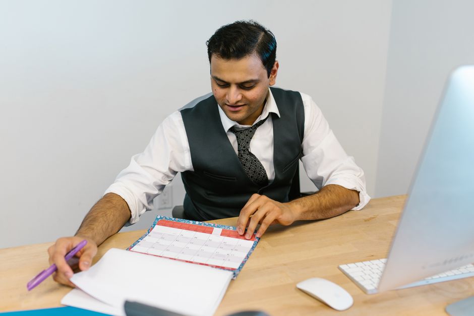 man planning his calendar at a desk after vasectomy